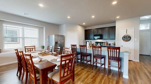Open-concept space connecting the dining area and full kitchen