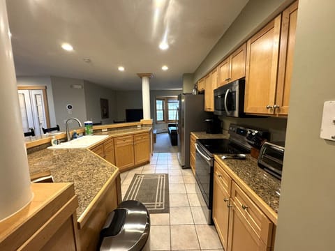 Fully equipped kitchen open to dining area. Seats 6