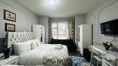 Deluxe Quadruple Room, Non Smoking, City View | Individually furnished, desk, laptop workspace, iron/ironing board