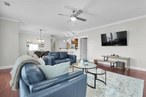 A sunlit, modern living room offering both comfort and style for relaxing moments.