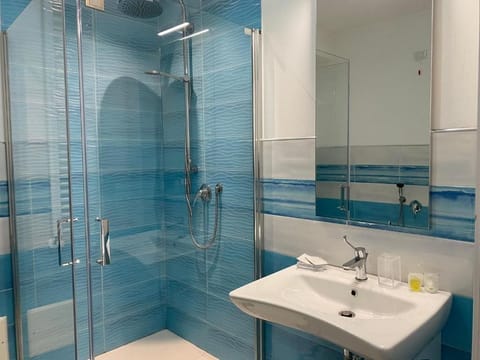 Shower, hair dryer, towels, toilet paper