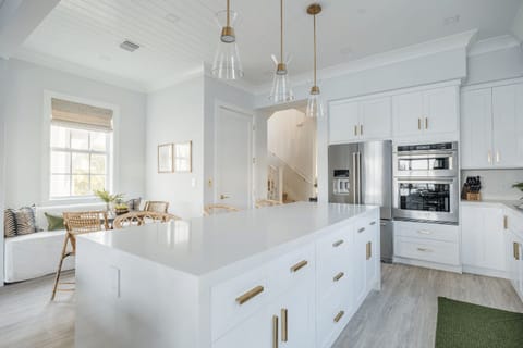 Spacious chef’s kitchen with oversized island and modern stainless appliances.