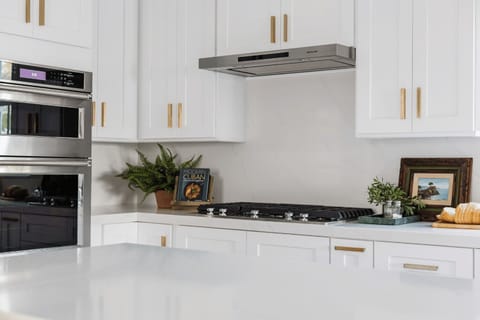 Gourmet kitchen with gas cooktop, double ovens, and custom cabinetry.