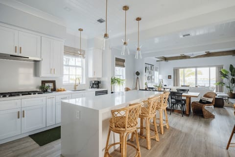 Bright chef’s kitchen with oversized island and open living flow.