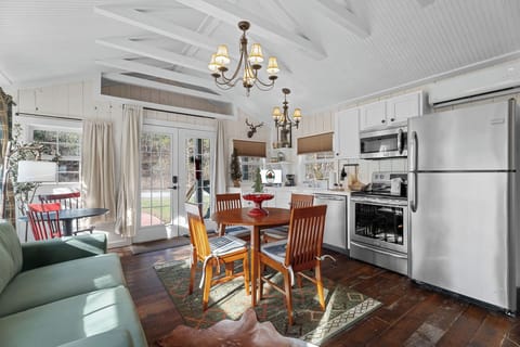 Open living space includes a fully equipped kitchen, living, and dining area