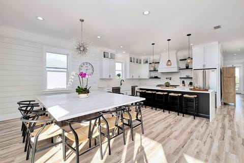 2nd Floor - Spacious dining room designed for large groups—seat 12 at the main table with room for 4 more at the marble kitchen bar. Perfect for family dinners, holiday meals, and gathering after a day at the beach in this luxurious Miramar Beach retreat.