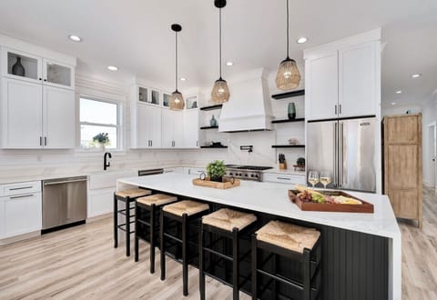 2nd Floor - Chef’s dream kitchen with Viking appliances, marble waterfall island, gas range, and seating for the whole group. Ideal for cooking, entertaining, and hosting unforgettable family meals. 