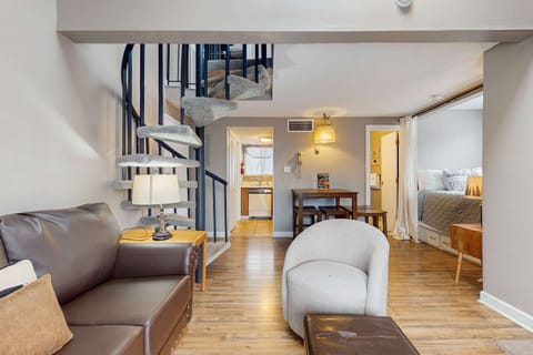 Living Room, spiral staircase leads to your hideaway, with relaxed seating and warm lighting!