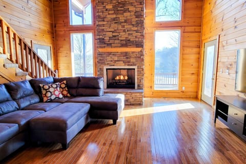 Experience stunning views and warmth by the stone fireplace in this inviting space!