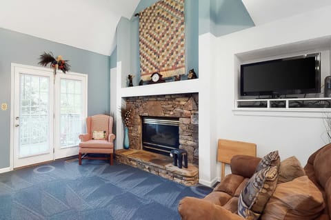 Relax by the stone fireplace, surrounded by charming decor and cozy seating!