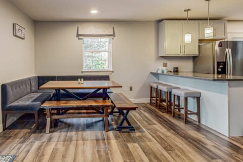 Spacious dining area with breakfast bar seating. Perfect for family dinners, group meals, holiday gatherings, and making memories in your cozy cabin retreat.
