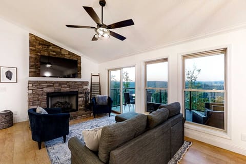 Unwind in style with stunning views and a warm stone fireplace ambiance!