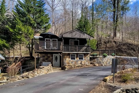 Charming cabin exterior awaits. And, enjoy nature from your private deck in this delightful mountain retreat!