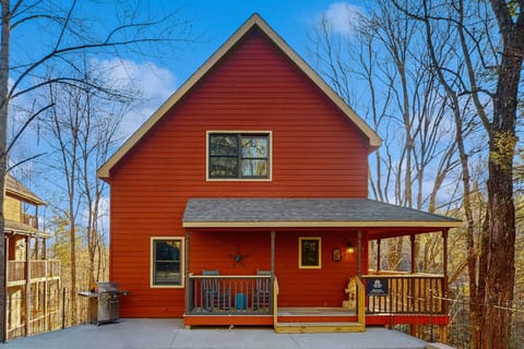 Exterior Retreat, enjoy stunning views from the spacious deck of this charming cabin in the woods!