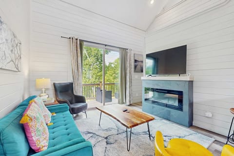 Relax in style with vibrant decor, a sleek fireplace, and stunning nature views!