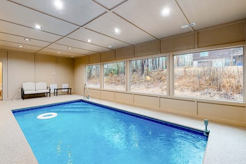 Private indoor pool with large windows overlooking the woods. Perfect for year-round fun. Rare Smoky Mountains cabin with indoor pool, ideal for families, groups, and luxury Gatlinburg or Pigeon Forge vacations.