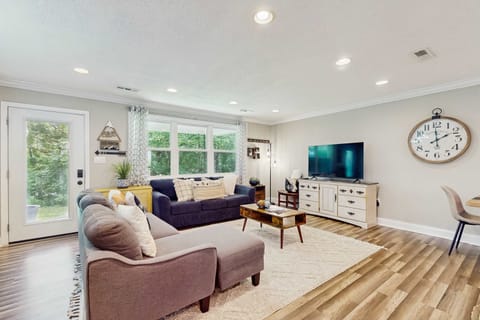 Your living room oasis awaits. Bright space with modern decor and nature views, perfect for relaxing evenings!