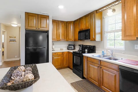 Fully equipped kitchen with range, microwave, fridge & lots of cabinets. Perfect for cooking and extended stays; great for families and groups, meal prep, coffee, and convenient lakehouse living.