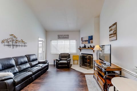 Bright living space with fireplace, TV, and comfortable seating. An inviting area for movie nights and relaxing together.