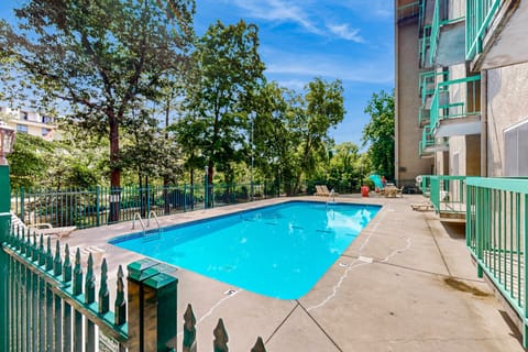 Dive into relaxation at our sparkling pool surrounded by lush greenery!