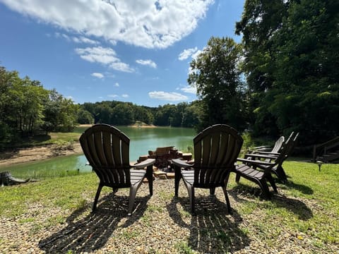 Lakeside Retreat, relax in stylish chairs by the shimmering water's edge, perfect for stargazing!
