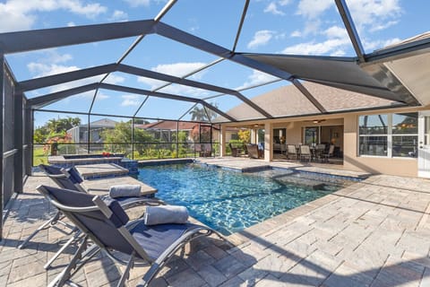 Your private resort oasis — heated pool, spa, sun loungers, and shaded lanai dining all in one stunning waterfront setting.