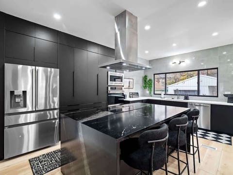 Spacious modern kitchen w/ dark cabinets & clean cooking space.