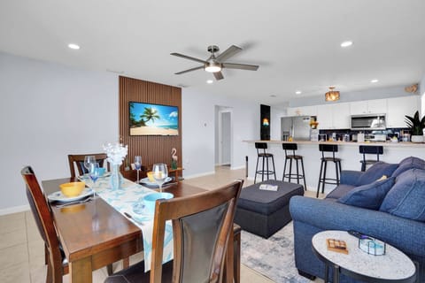 Open living and kitchen area featuring comfortable seating and a flat-screen TV.