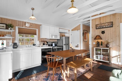 The open concept space features a fully equipped kitchen, along with a dining area and a living room