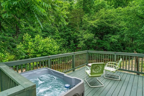 Spacious deck overlooking Brushy Creek, complete with outdoor seating and a hot tub for two.