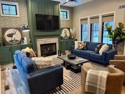 Main living space with gas fireplace, lots of seating and a 65" TV