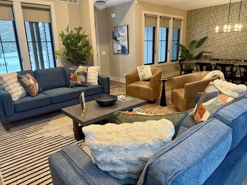 Main living space with gas fireplace, lots of seating and a 65" TV