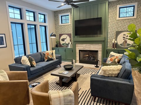 Main living space with gas fireplace, lots of seating and a 65" TV