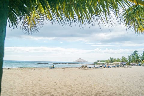 On the beach, white sand, free beach cabanas, beach umbrellas