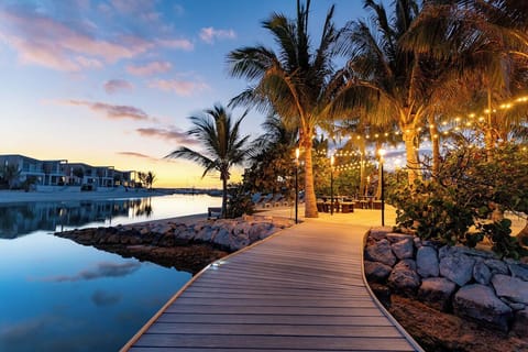 Stroll along the lantern-lit boardwalk at dreamy sunset.