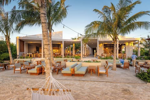 Unwind under swaying palms with sunset cocktails and conversation.