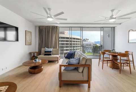 Full-height glass doors fill the lounge with natural light and open to sweeping views, creating an inviting indoor-outdoor flow perfect for unwinding after a day by the water.