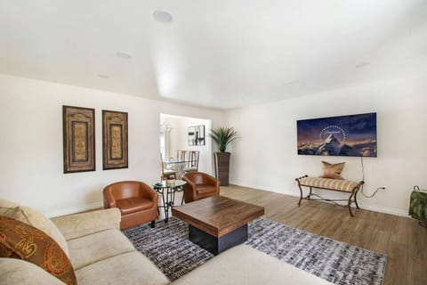 Bright and cozy living room with comfortable seating and Smart TV