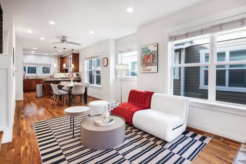 Red-and-white designer sofa adds a playful pop of color to the main living area.