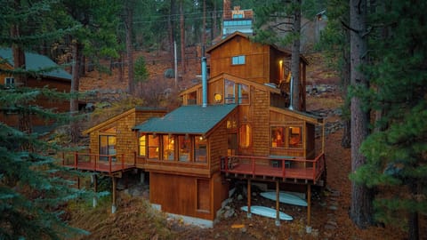 Expansive multi-level cabin tucked into the pines, offering warm interiors and wraparound decks with serene forest and lake views.