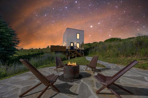 Outdoor fire pit area with seating, perfect for relaxation under a stunning night sky.