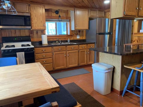 View of kitchen from the entry way. Full kitchen set up ready to eat in. Grill