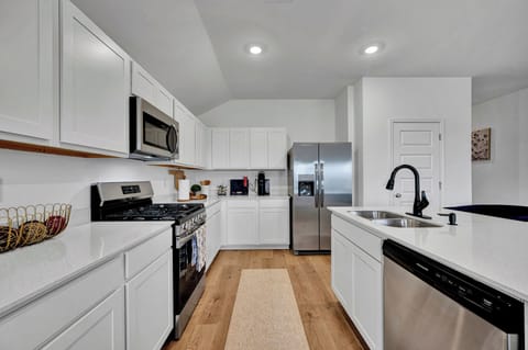 Fully equipped kitchen with island and stainless steel appliances