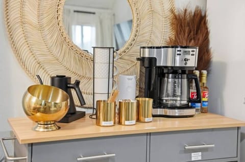 Stylish coffee bar with drip maker and Fellow kettle.