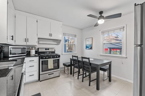 Whip up delicious meals in your sleek, fully-equipped kitchen with modern appliances, ample counter space, and a cozy dining nook perfect for morning coffee.