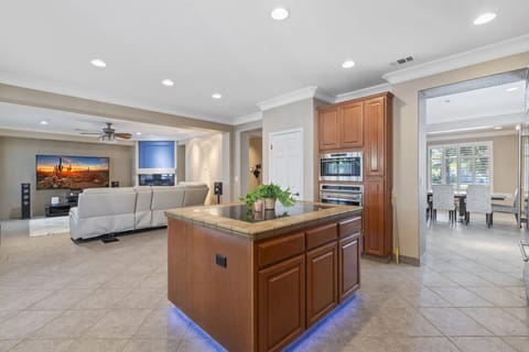 Enjoy a stylish kitchen featuring a spacious island table at the center, perfect for dining or gathering.