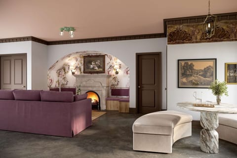 The living area features a cozy fireplace and chic design elements. 