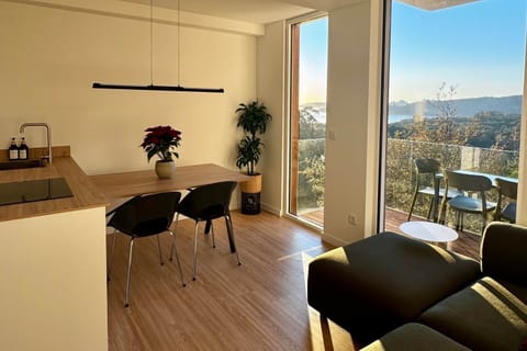 Light-filled open living space with private balcony and sweeping sea and mountain views.