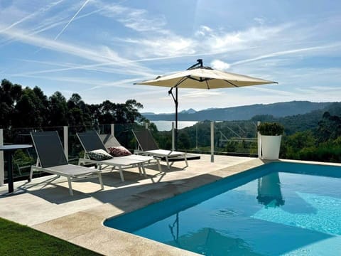 Beautiful shared pool with views, sun loungers, and relaxed vibe.