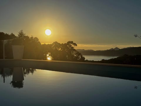 Sunset by the pool, open sea views and the sound of the ocean in the background.